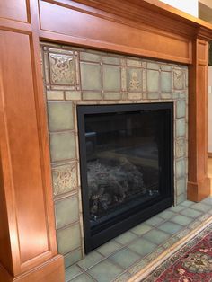 a fireplace in a living room with a rug on the floor