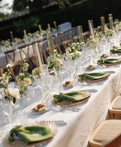 a long table is set with plates and place settings