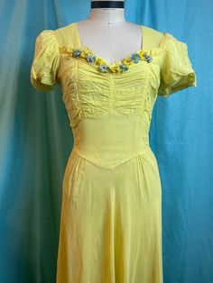 "1930s W:26\" pale yellow sheer nylon silk short flutter puff sleeve gathered bust bias cut velvet flowers sweetheart  Beautiful one of a kind vintage 30s/40s sheer yellow dress. Bias cut. Sweetheart neckline with vertical shirred bust, neckline adorned with blue and yellow flowers.Flutter puff sleeve. Fitted, pointed waist yoke with ties. A line, paneled bias cut skirt with gathers. Skirt lined. Deco brass side seam bodice zipper.  MEASUREMENTS  Bust: 30\" Waist: 26\" Hips: 36\"  Bodice length: Fitted Yellow Vintage Dress With Short Sleeves, Yellow Fitted Vintage Dress With Short Sleeves, Yellow Fitted Short Sleeve Vintage Dress, Fitted Yellow Vintage Dress For Summer, Gathers Skirt, Sheer Yellow Dress, Rp Outfits, Floor Length Maxi Dress, Bias Cut Skirt