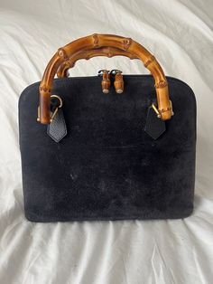 Gorgeous rare vintage Gucci Mini Diana Bag in excellent condition!  100% Authentic vintage navy suede Gucci top handle bag  5"x7"x 2"   Some wear in the suede  Gold-Tone Hardware  Bamboo Handles  Leather Trim Embellishment  Canvas Lining & Single Interior Pocket  Zip Closure at Top Bamboo Handle Bag, Gucci Top Handle Bag, Gucci Top, Gucci Mini, Top Handle Bags, Bamboo Handles, Handle Bag, Leather Trim, Vintage Gucci