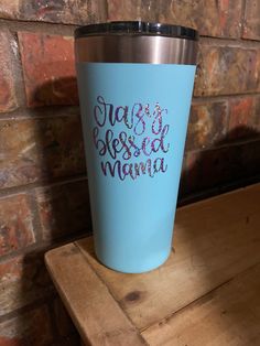 a blue tumbler cup with the words jesus is blessing mama on it sitting on a wooden table