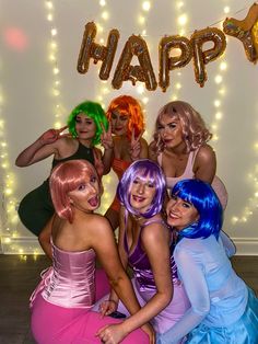 a group of women posing for a photo in front of a happy birthday sign with balloons