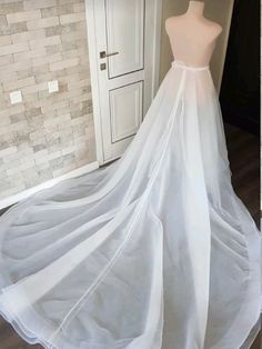 a wedding dress on display in front of a mannequin