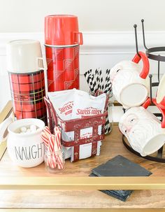 a table topped with lots of different types of cups and saucers on top of a wooden table