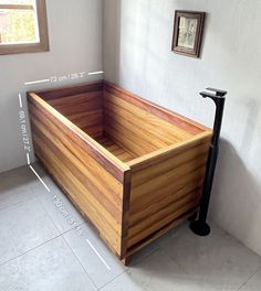 a wooden bathtub sitting on top of a tiled floor