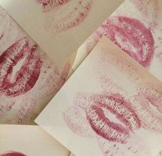 some pink lipstick prints on white paper