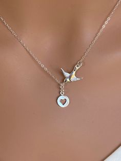 Sterling silver bird necklace. Dove Bird Necklace, Heart Necklace. This necklace express for love and friendship All metal components onto 925 Sterling Silver. This beautiful necklace consists of, -Sterling Silver Dove Pendent, -8mm Sterling Silver Heart cut out charm, -Sterling Silver end to end to Spring Claw. -Come up with beautiful ribbon gift box -One set of care instruction package that enhance your present. -All quantities are available please contact me for different number of quantities Nickel Free Sterling Silver Jewelry In Bird Shape, Silver Charm Necklace For Birthday With Lobster Clasp, Silver Charm Necklace For Birthday Gift, Silver Bird Shaped Jewelry For Gifts, Silver Bird-shaped Jewelry For Gift, Silver Bird-shaped Jewelry As Gift, Nickel-free Bird-shaped Jewelry Gift, Gift Jewelry With Bird Design Round Pendant, Necklace With Round Pendant And Bird Design For Gifts