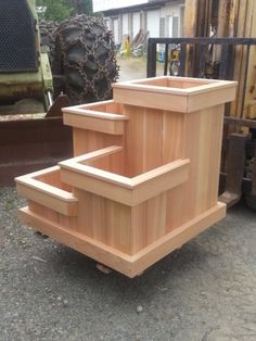 a wooden box sitting on top of a pile of wood