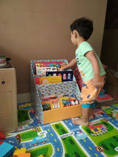 a little boy playing with his toys in the living room