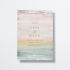 an elegant save the date card with watercolor paint and gold foil on it, in paste