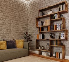 a couch sitting in front of a book shelf with books on it's sides