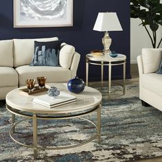 a living room with two couches and a coffee table in front of a blue wall