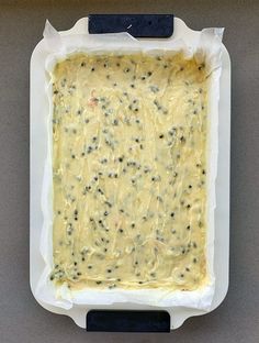 an uncooked casserole in a white dish on a gray countertop