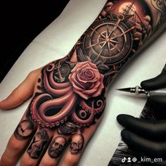 a hand with an octopus and rose tattoo on it