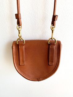 Classic Brown Belt Bag With Detachable Strap, Cognac Saddle Bag With Gold-tone Hardware For Everyday, Everyday Cognac Saddle Bag With Gold-tone Hardware, Cognac Saddle Bag With Gold-tone Hardware, Classic Belt Bag With Gold-tone Hardware For Travel, Leather Saddle Bag With Belt Loops, Crossbody, Leather Crossbody Saddle Bag With Belt Loops, Brown Saddle Bag With Brass Hardware, Brown Saddle Bag With Metal Hardware For Everyday Use