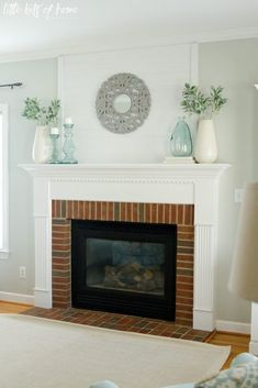 a living room filled with furniture and a fire place in front of a white fireplace