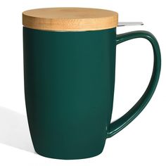 a green coffee cup with a wooden lid