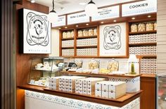 the inside of a bakery with cookies on display