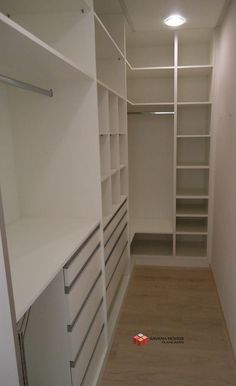 an empty walk in closet with shelves and drawers