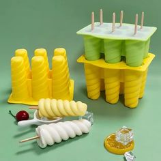 there are many plastic objects on the table together, such as popsicles and lemons