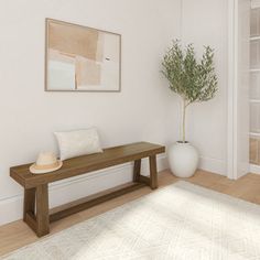 a white room with a wooden bench and potted plant