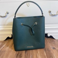 Michael Kors Suri Saffiano Leather Bucket Bag In Racing Green. New, Never Used. Excellent Condition. Comes With Tags And Shoulder Strap. 9x8x4.5 Smoke And Pet Free. Originally Priced 398 Elegant Green Top Handle Bucket Bag, Elegant Green Bucket Bag For Shopping, Elegant Green Leather Bucket Bag, Formal Green Bucket Bag With Removable Pouch, Elegant Green Bucket Shoulder Bag, Green Formal Bucket Bag, Classic Green Michael Kors Bag, Formal Michael Kors Saffiano Leather Shoulder Bag, Chic Green Michael Kors Bag