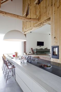 the kitchen is clean and ready to be used for cooking or eating, while the dining room also has an open floor plan