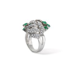 Fall in love with this one-of-a-kind vintage white gold Diamond and Emerald Floral Motif ring. With seven emeralds and forty-six diamonds, it's a classic piece radiating both elegance and charm. Available in 18K White Gold Available in a size 7 Ring can be resized between sizes 6-8 for an additional fee. Please contact our team at info@stephaniegottlieb.com for more information. Green Emerald weight = 0.78 carats Diamond weight = 0.72 carats Diamond quality = FG color, VS clarity Origin = German Diamond Cocktail Rings, Band Bracelet, Diamond Shop, Bracelet Collection, Green Emerald, Earrings Collection, Ring Collections, Vintage Diamond, Diamond Bands