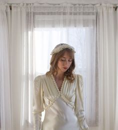 *HEADPIECE ONLY. DRESS NOT INCLUDED*  1920's flapper style bridal headpiece.  Unique pinwheel design with wax flowers across the back and lace over the top. It can be worn with the flowers in the front or back. I've shown it both ways. I think would look really pretty with a drop style veil!  *Condition* Very good vintage condition. The lace over the top is rather delicate and some tiny breaks in the lace are present but not noticeable. *All Sales Final* Please read listings carefully and compar Vintage Fitted Headpieces For Wedding, Vintage Wedding Headband, Art Deco Wedding Headpiece, Vintage Fitted Wedding Headpiece, Vintage Wedding Headband Headpiece, 1920s Wedding Dress And Veil, Vintage Cream Headpiece For Wedding, 1920s Wedding Headband, Vintage Cream Headpieces For Vintage Events