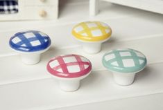 four different colored checkered knobs on a white counter top with text overlay