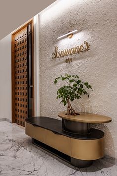 a plant is sitting on top of a table in front of the entrance to a restaurant