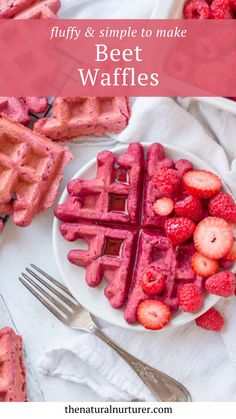 a white plate topped with waffles covered in raspberries