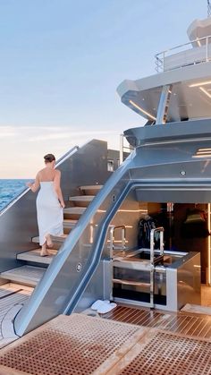 a woman is walking up the stairs on a boat