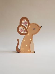 a light up dog figurine with flowers on its back