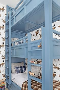 a blue bunk bed with horses on the wall