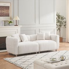 a white couch and ottoman in a living room