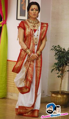 a woman in a red and white sari