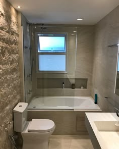 a bathroom with a tub, toilet and sink