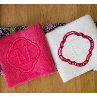 three towels with embroidered monograms on them, one in pink and one in white