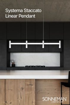 an image of a kitchen with black cabinets and white counter tops that has the words systema staccato linear pendant on it