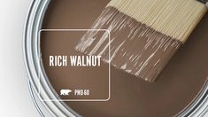 a can of brown paint with the words rich walnut on it and a white brush