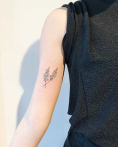 a woman with a small tattoo on her arm