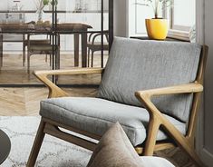 a living room filled with furniture next to a dining room table and chairs on top of a hard wood floor