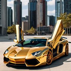 a gold colored sports car parked in front of some tall buildings with its doors open