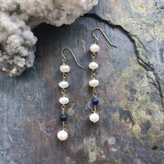 "Freshwater Pearls strung on 14k gold-filled wire with dark Lapis Lazuli to catch the eye. Large freshwater pearl at the base of the strand. Earrings are 3 1/2\" in length from the top of the ear wire to base of the earring." Handmade 14k Gold Filled Dangle Linear Earrings, 14k Gold Filled Drop Earrings With Natural Stones, 14k Gold Filled Natural Stone Drop Earrings, Wire Wrapped 14k Gold Filled Dangle Pearl Earrings, 14k Gold Filled Wire Wrapped Dangle Pearl Earrings, Dainty 14k Gold-filled Earrings With Natural Stones, Elegant Wire Wrapped Lapis Lazuli Earrings, Elegant Lapis Lazuli Wire Wrapped Earrings, Wire Wrapped Lapis Lazuli Dangle Earrings