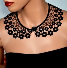 a mannequin wearing a black lace collar necklace