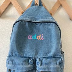 "The cutest backpack! I love how casual and simple these are. Choose from initial, name, or first and middle name on these lightweight denim bags. The back measures 15.7\" x 11.7\"8 and comes with two smaller front pockets, a main large pocket and adjustable shoulder straps. These backpacks are the perfect size for toddlers and kids but adults as well! If you are wanting a different design, size, more wording, or a different clothing style, please send me a message so we can discuss the details. Casual Backpack For Everyday And End Of School Year, Casual Backpack With Embroidered Logo For Daily Use, Casual Embroidered Everyday Backpack, Casual Personalized Everyday Bag, Casual Everyday Personalized Bags, Casual Everyday Embroidered Backpack, Embroidered Backpack For Everyday And Back To School, Trendy Embroidered School Backpack, Casual Backpack With Embroidered Logo