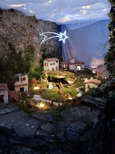 a fake village is shown in the middle of a mountain area with lights on it