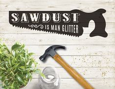 there is a potted plant with a hammer next to it and a sign that says sawdust is man gutter