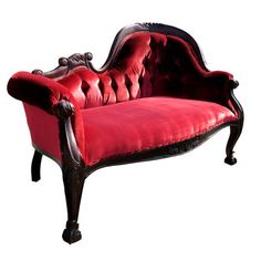 an old fashioned red velvet couch with black trimmings and wood frame, on white background